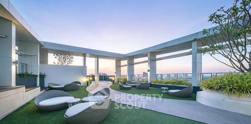 Luxurious rooftop terrace with modern seating and stunning city views at sunset.
