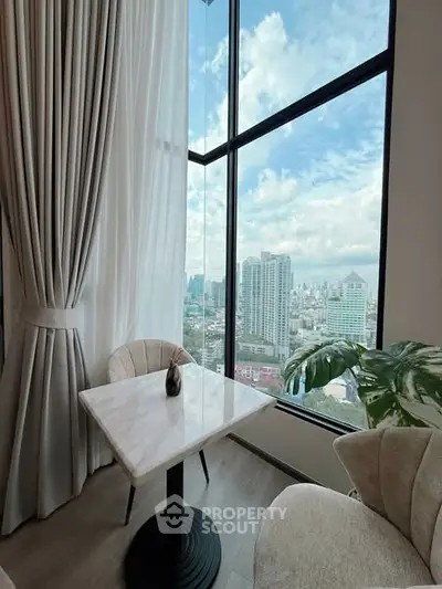 Stunning high-rise view from a modern apartment with floor-to-ceiling windows and elegant decor.