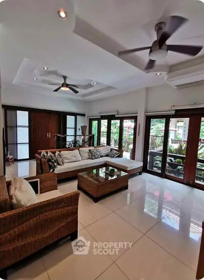 Spacious living room with modern decor and large windows for natural light