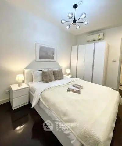 Cozy bedroom with modern lighting and elegant decor, featuring a comfortable bed and ample storage.