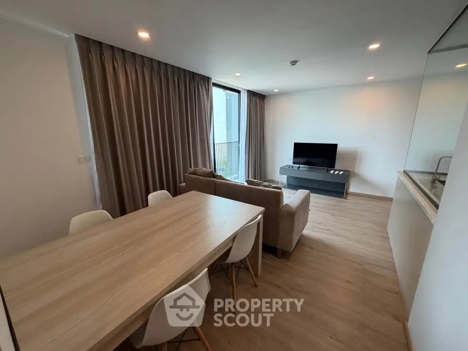 Modern living room with sleek furniture and natural light, perfect for relaxation and entertainment.