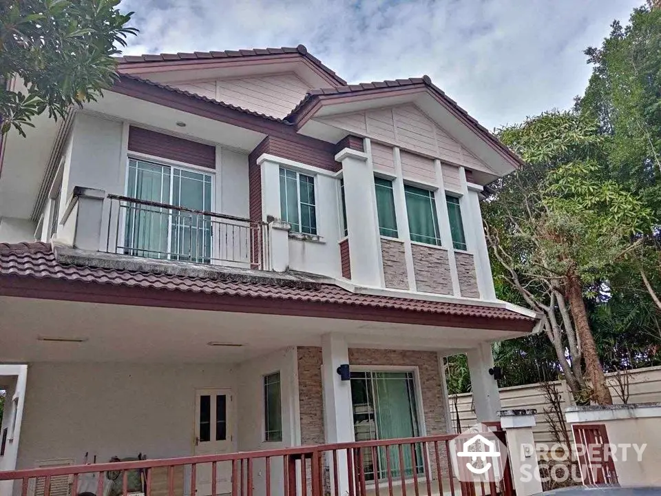 Charming two-story house with modern design and spacious balcony in a serene neighborhood.