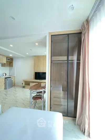 Modern studio apartment with open kitchen and stylish furniture