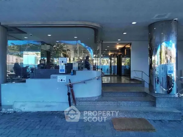 Modern building entrance with sleek glass doors and polished metal accents.