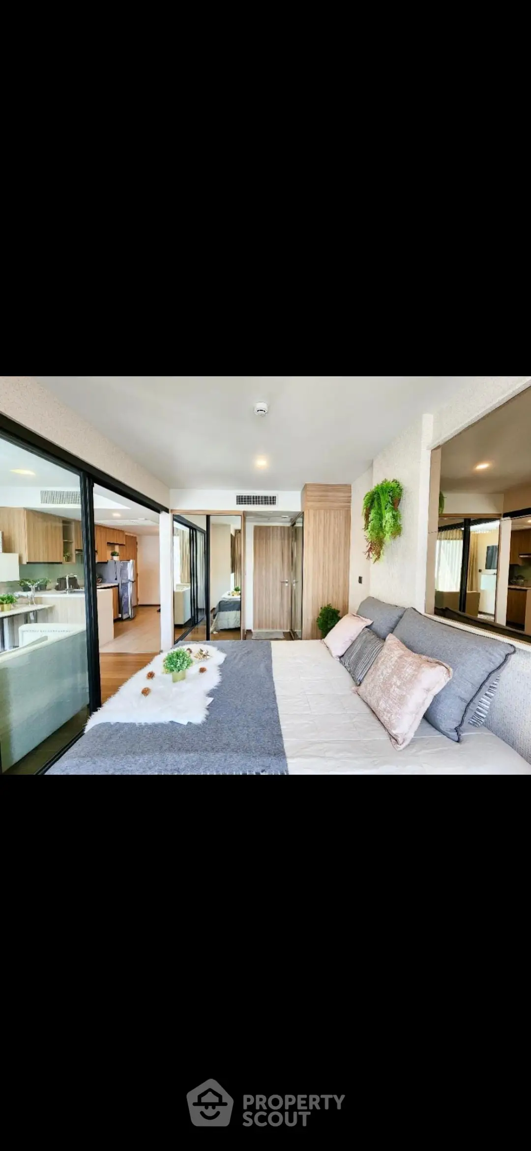 Luxurious bedroom with modern decor and sliding glass doors leading to a spacious living area.
