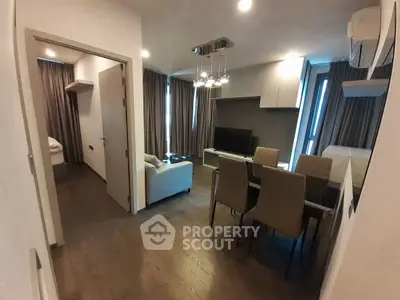 Modern living room with dining area and stylish decor in a cozy apartment.