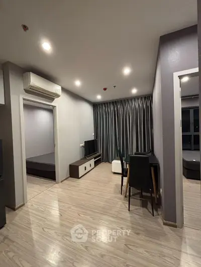Modern living room with sleek design and open layout, featuring stylish furniture and ambient lighting.