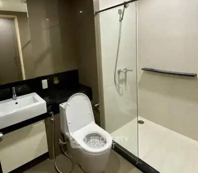 Modern bathroom with sleek shower and contemporary fixtures in a stylish apartment.