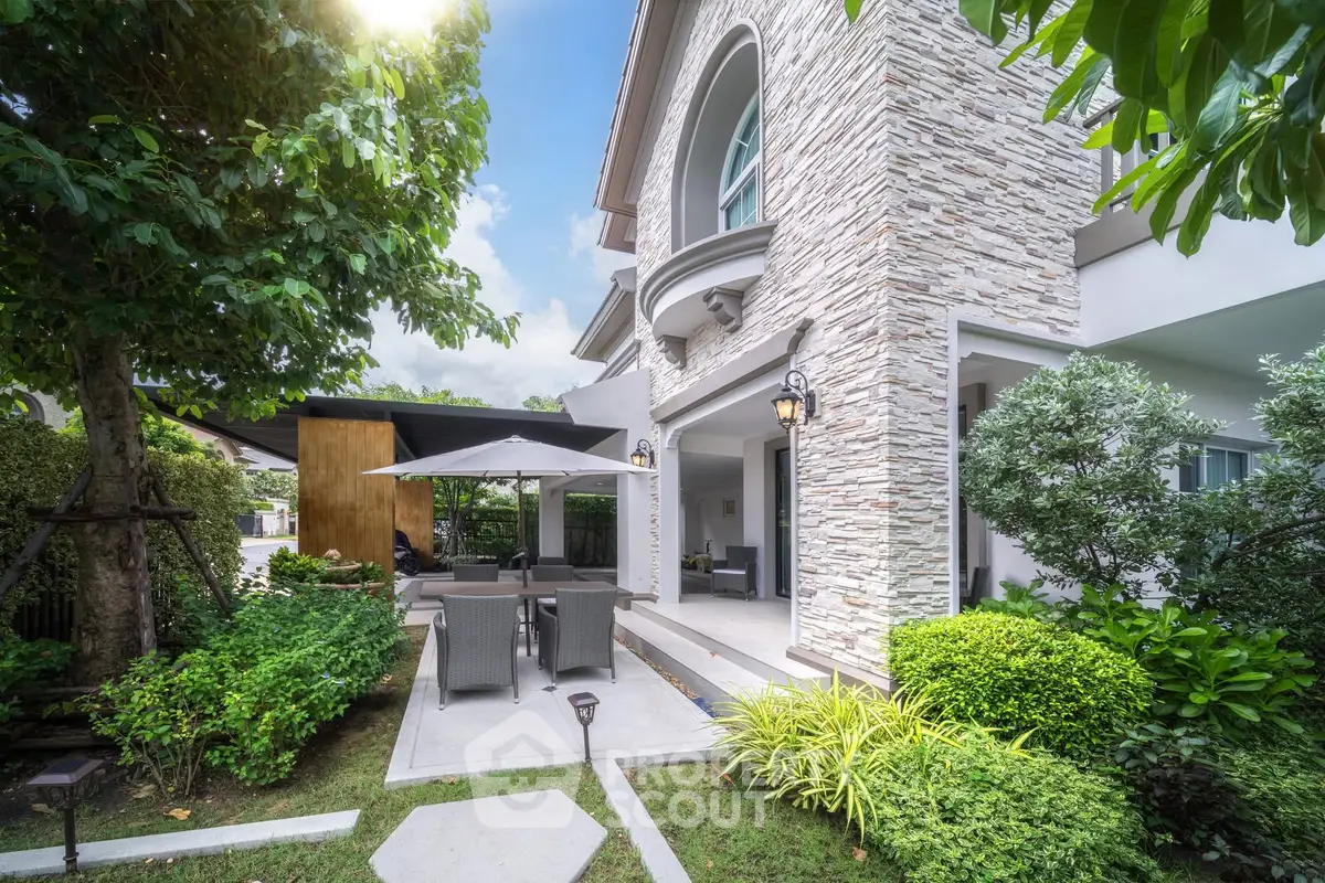 Charming modern house with lush garden and outdoor seating area, perfect for relaxation and entertaining.
