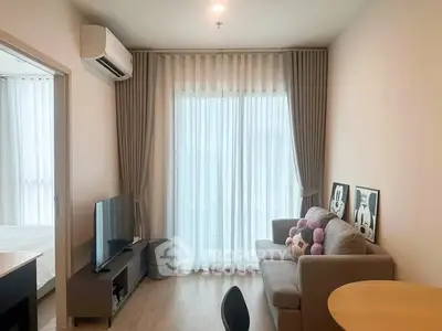 Modern living room with cozy sofa, TV, and large window with curtains in a stylish apartment.