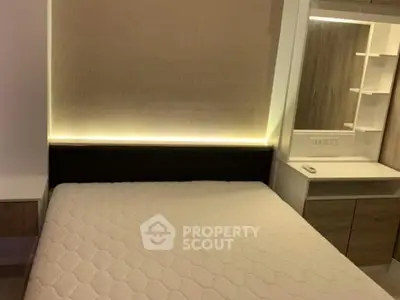 Modern bedroom with stylish lighting and built-in storage solutions.