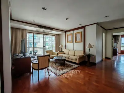 Spacious living room with elegant furniture and large windows offering natural light.