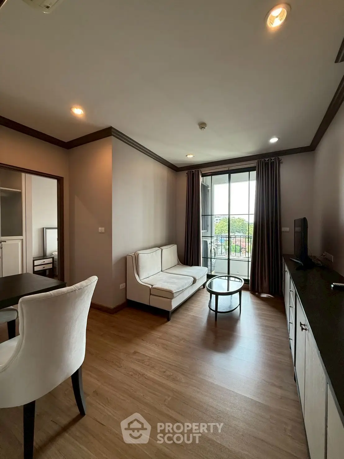 Modern living room with elegant furniture and balcony view