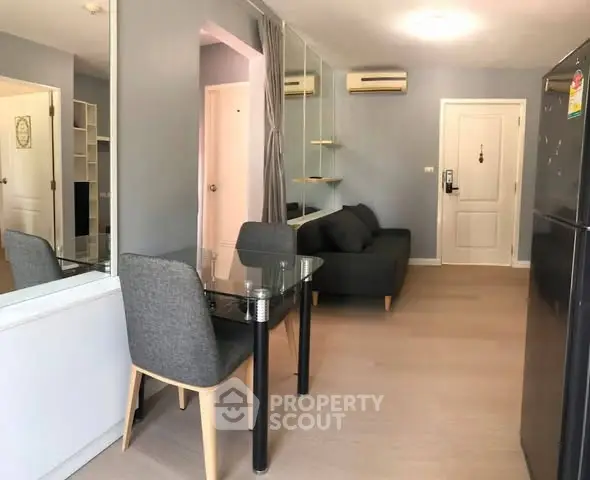 Modern living room with sleek furniture and air conditioning in a stylish apartment.