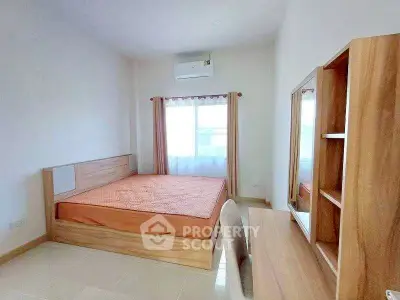 Spacious bedroom with modern wooden furniture and natural light