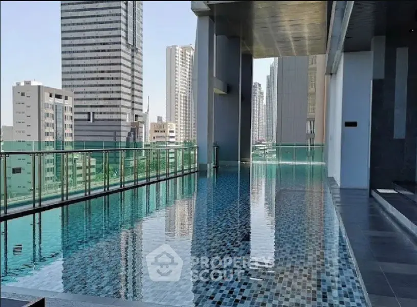 Luxurious rooftop pool with stunning cityscape views in modern high-rise building.