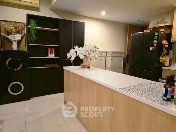 Modern kitchen with sleek black appliances and elegant wooden cabinetry