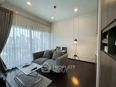 Modern living room with city view, featuring sleek furniture and elegant decor.