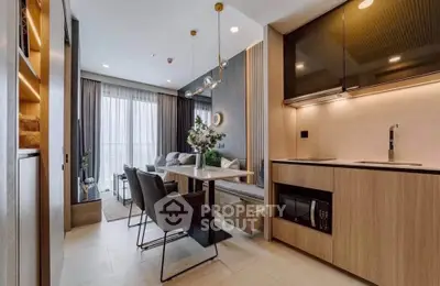 Modern open-layout kitchen and dining area with stylish decor and natural light.