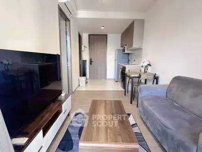 Modern living room with open kitchen layout and stylish furnishings