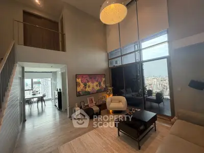 Spacious modern living room with high ceilings and city view balcony