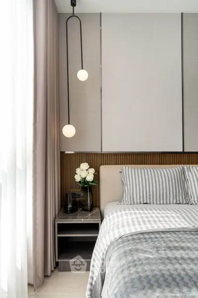 Modern bedroom with stylish decor and cozy ambiance, featuring elegant lighting and soft furnishings.