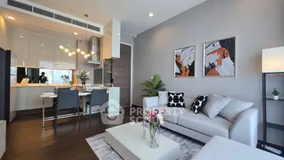 Modern open-plan living room with stylish decor and kitchen area