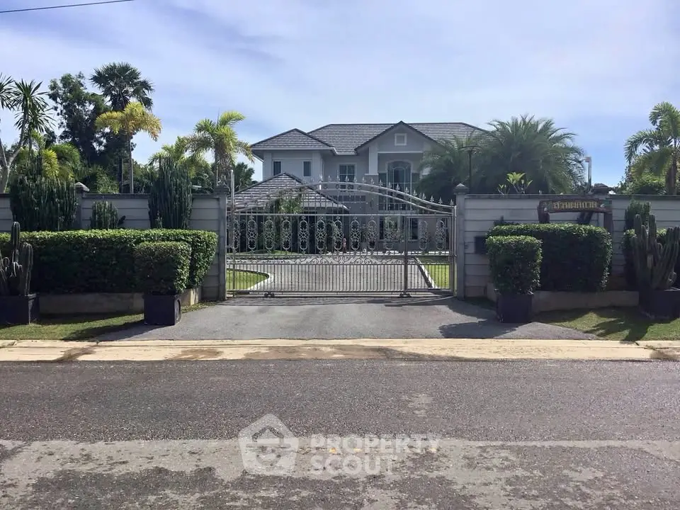 Luxurious gated estate with lush landscaping and elegant architecture