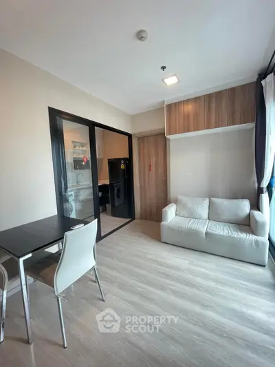 Modern living room with sleek furniture and wooden accents in a stylish apartment.