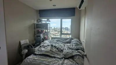 Cozy bedroom with city view, featuring a comfortable bed and modern decor, perfect for urban living.