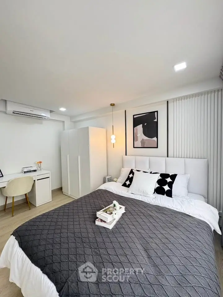 Modern bedroom with stylish decor and cozy ambiance, featuring a comfortable bed and elegant furnishings.