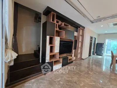 Luxurious living room with modern built-in shelving and elegant marble flooring