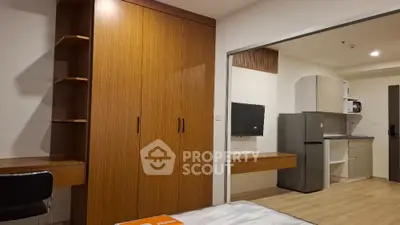 Modern studio apartment with built-in wardrobe and compact kitchen area