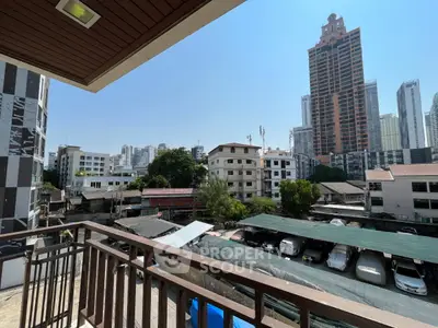 Spacious balcony with urban cityscape view, perfect for enjoying the skyline and vibrant surroundings.