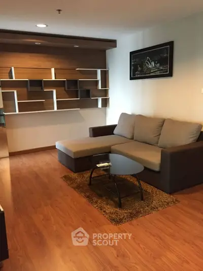 Modern living room with stylish sectional sofa and unique wall shelving