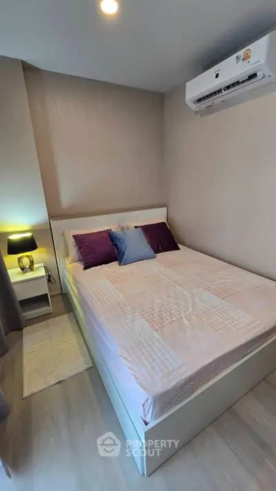 Cozy bedroom with modern decor and air conditioning, perfect for restful nights.