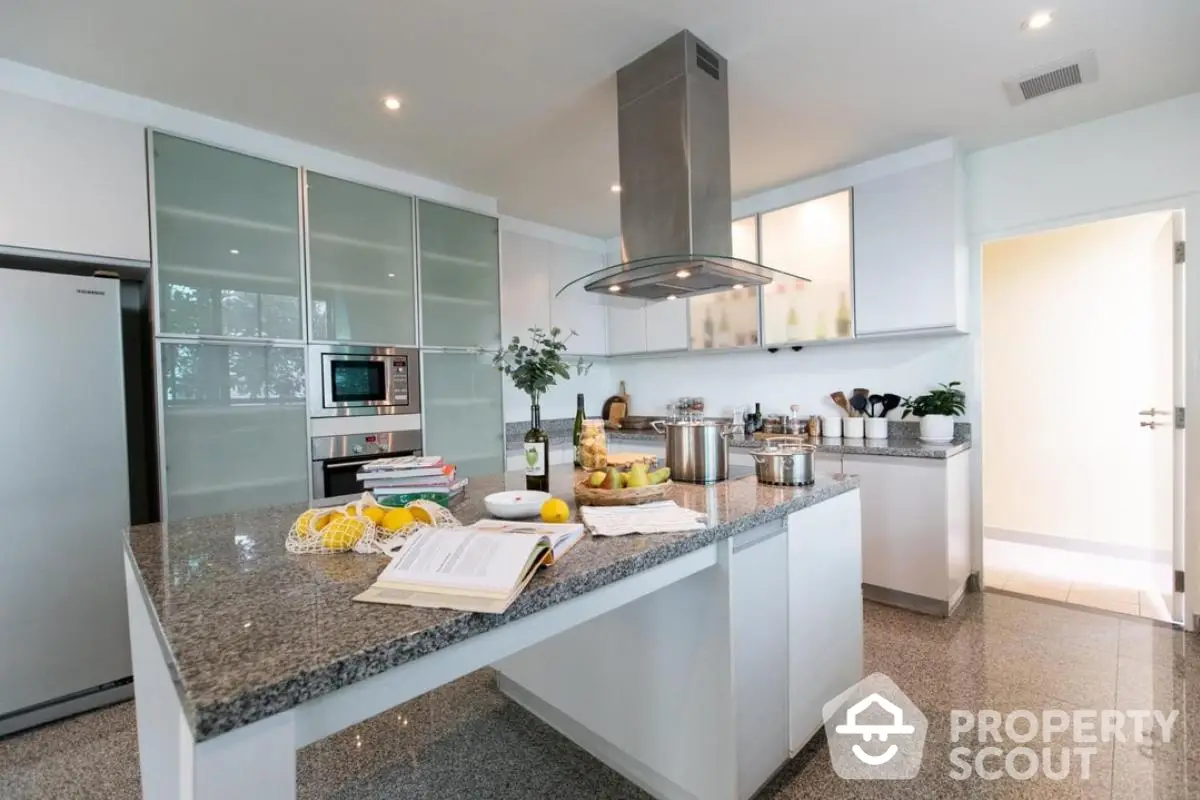 Modern kitchen with sleek design, granite countertops, and stainless steel appliances.