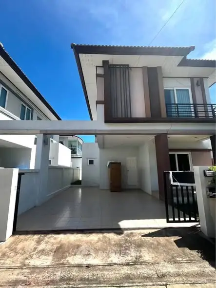 Modern two-story house with driveway and contemporary design in a sunny neighborhood.