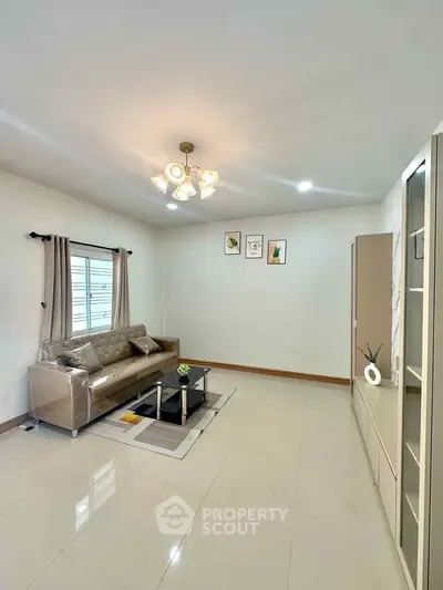 Spacious living room with modern decor and elegant lighting, perfect for relaxation and entertainment.