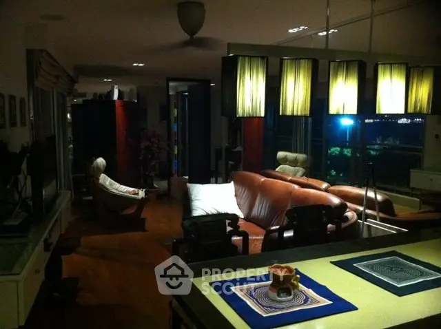 Luxurious living room with elegant lighting and plush leather seating, perfect for relaxation and entertainment.