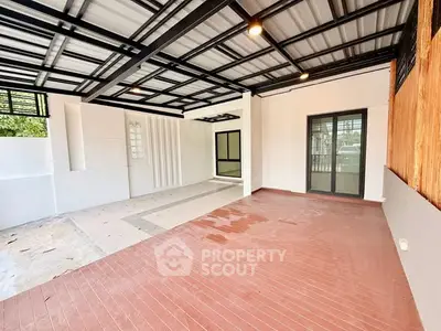 Spacious modern covered patio with sleek design and ample natural light.
