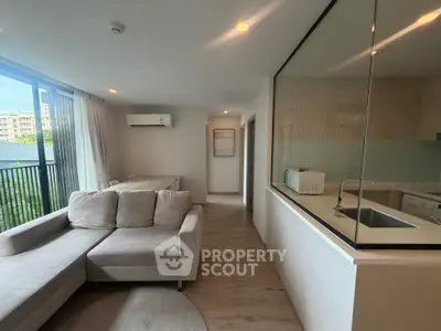 Modern living room with open kitchen and large window view