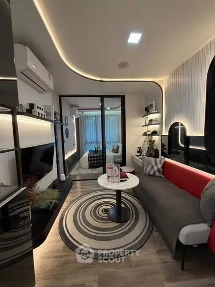 Modern living room with stylish decor and ambient lighting, featuring a cozy seating area and sleek entertainment setup.