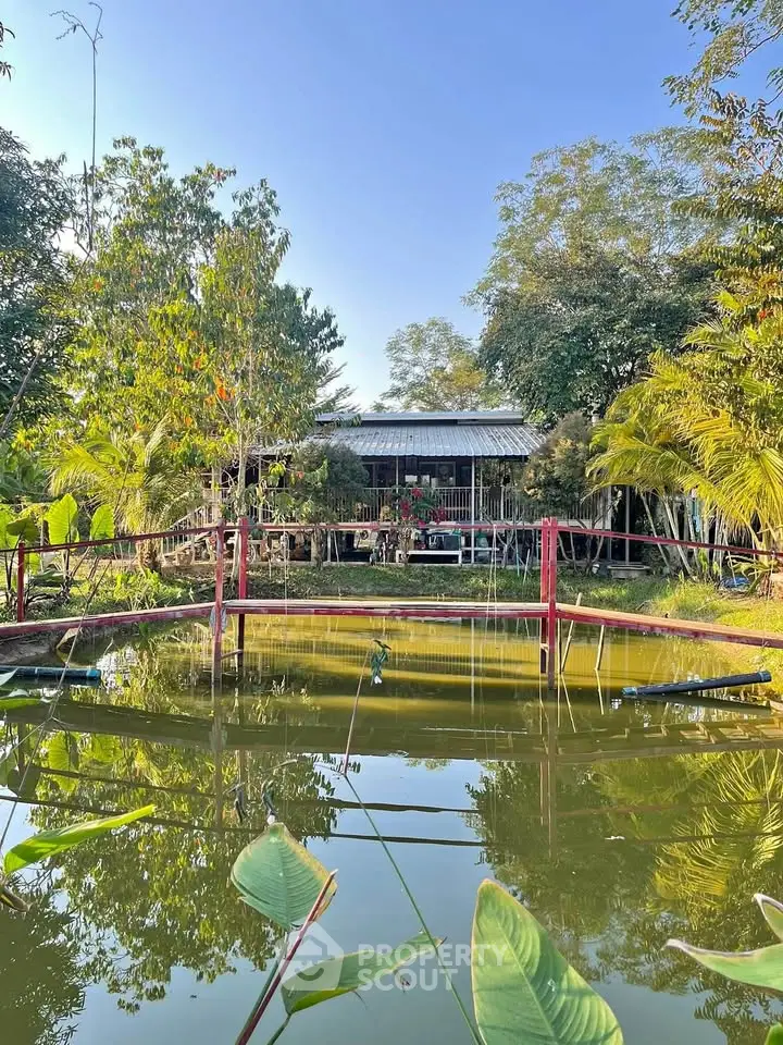 Charming rural property with serene pond and lush greenery, perfect for nature lovers seeking tranquility.