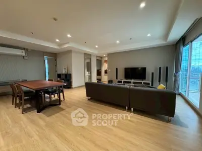 Spacious modern living room with wooden flooring and large windows