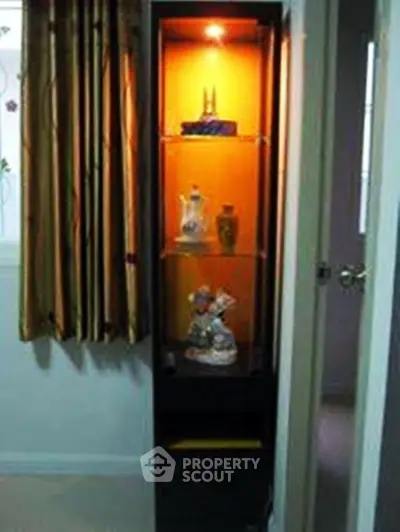 Elegant display cabinet with decorative items in a cozy room corner