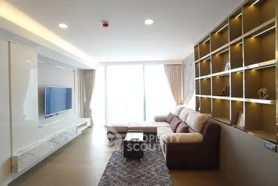 Modern living room with large sectional sofa and built-in shelving