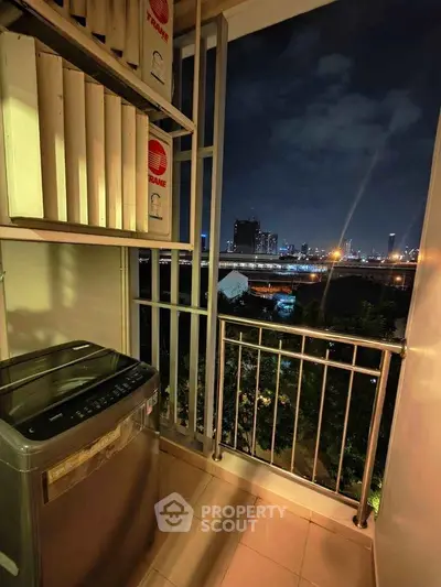 Charming balcony with city skyline view, featuring a washing machine and ample storage space.
