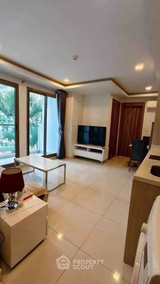 Modern living room with large windows and stylish decor in a contemporary apartment.