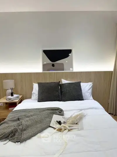 Cozy bedroom with modern decor and soft lighting, perfect for relaxation.